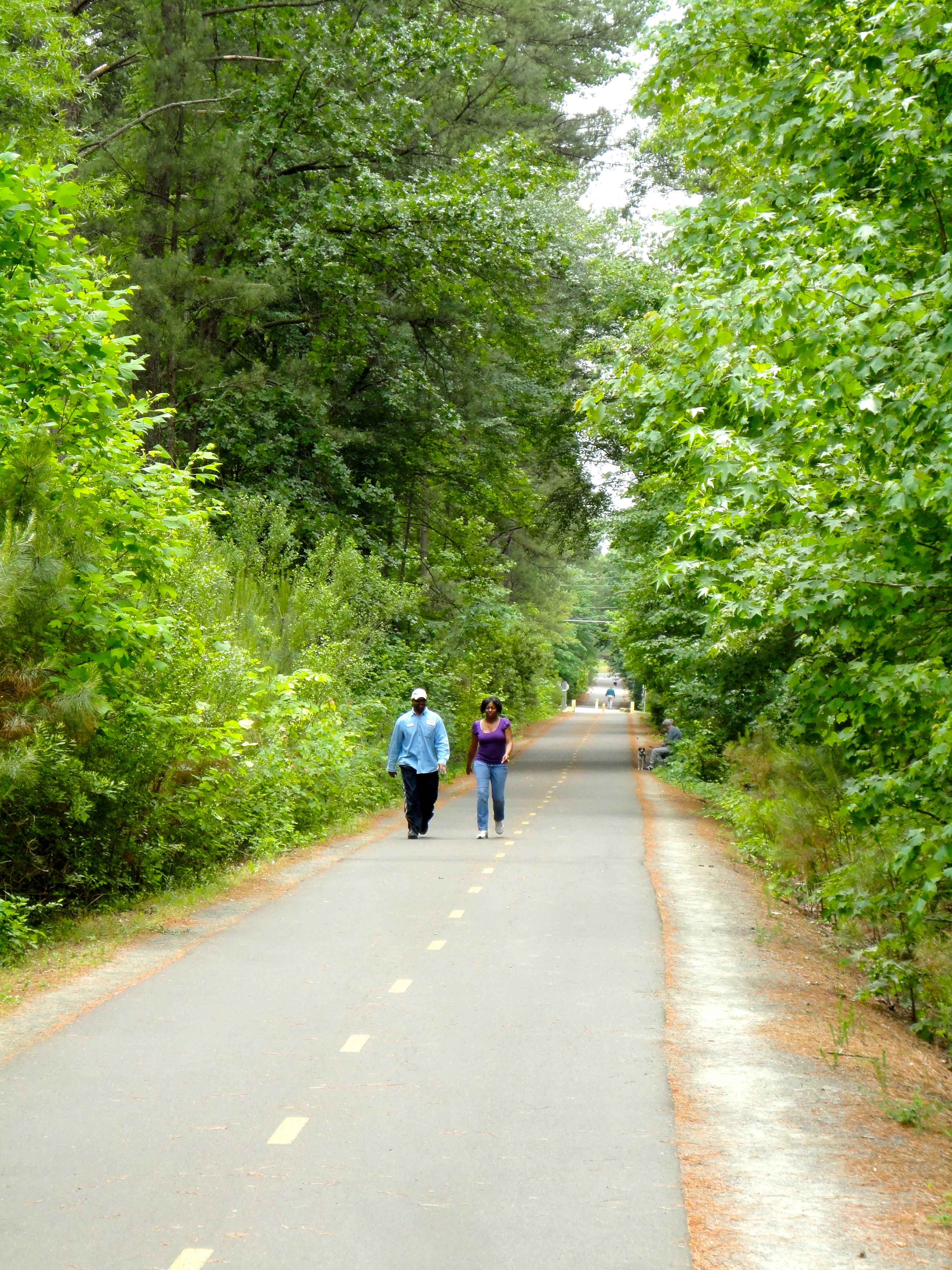 Two people walk a trail