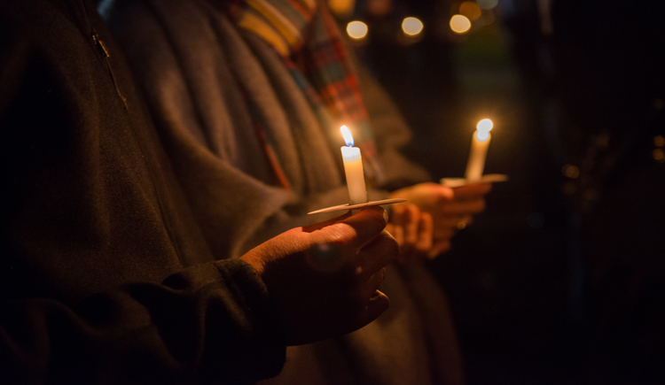 Participants in the Tree of Life Ceremony hold candles in memory of those who lost their lives in vehicle-related crashes