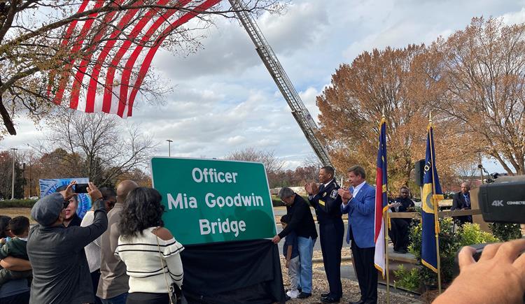 Family members unveil the Officer Mia Goodwin Bridge sign. 