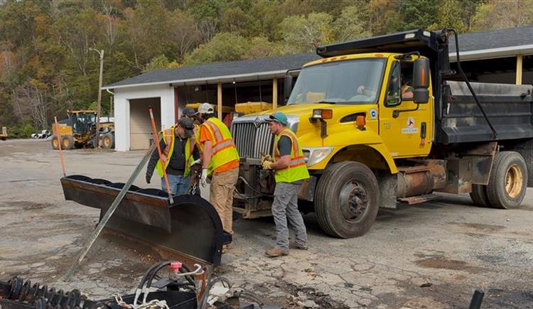 NCDOT employees in Watauga County attach a snowplow to a dump truck on Wednesday, Oct. 8. 
