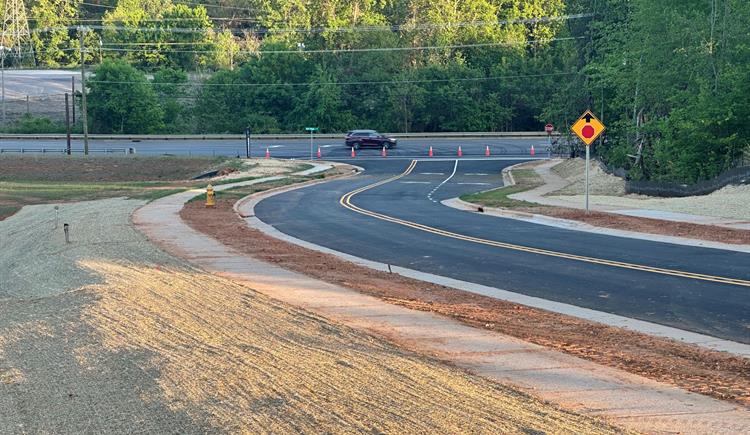 Cars on N.C. 150 drive by Cambrey Pointe Drive in Iredell County.