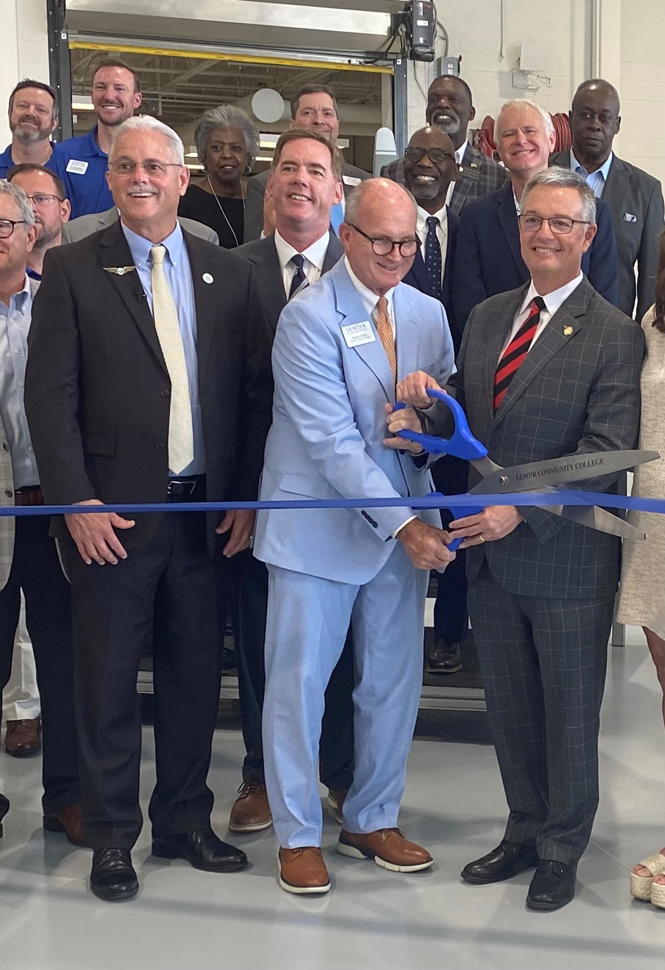Officials cut a ribbon to celebrate the opening of a new aviation center in Kinston.