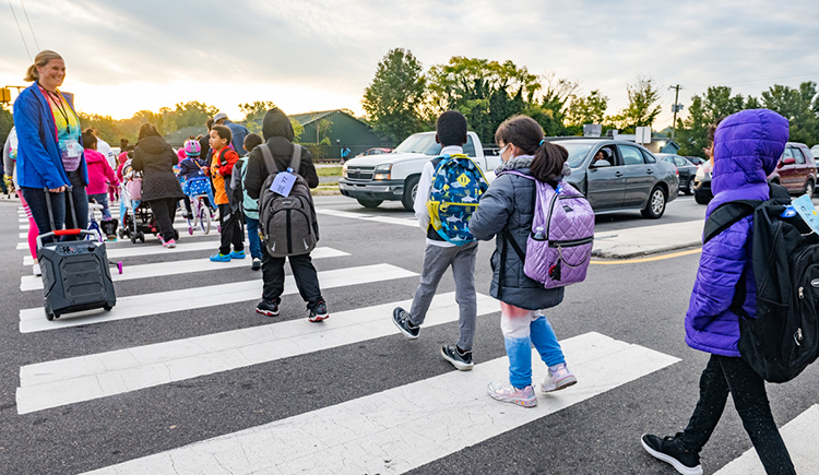This photo shows children walking across a crosswalk.
