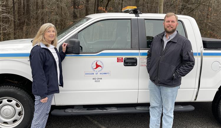 Sybil and Bobby stand in front of the NCDOT truck where the wallet was first found.